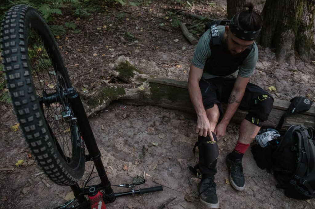 Man Putting On Protective Gear for Mountain Biking