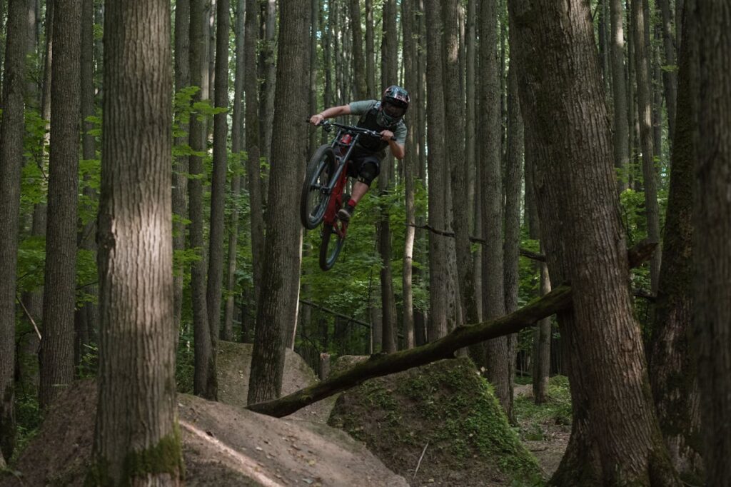 Cyclist Jumping on Ramps in the Forest